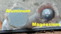 An aluminum anode with flat hex head is compared to a magnesium one with a hex head with a bump