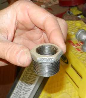 A reducer bushing for using 3/4-inch fittings in a one-inch port